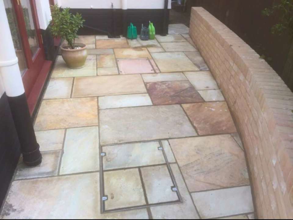 Curved patio with seating area in Suffolk garden